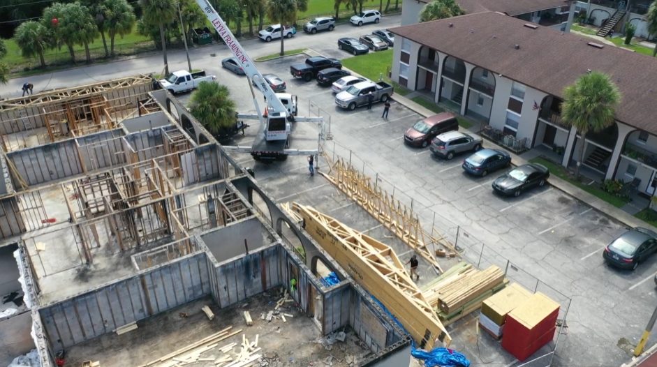 Aerial view of new roof truss installation on a multi-family building by Cmax GC